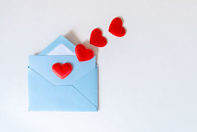 High angle view of heart shape on paper against white background