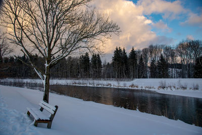 Scenic view of frozen lake against sky during winter