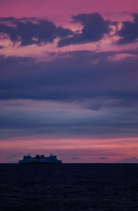 Scenic view of sea against orange sky