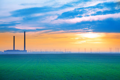 Scenic view of field against sky during sunset