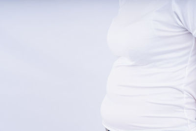 Rear view of woman standing against white background