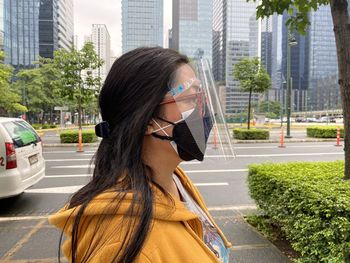 Portrait of woman with face mask on city street