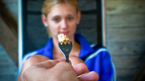 Cropped hand holding fork by woman