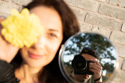 Portrait of woman photographing