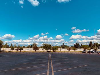Surface level of parking lot against blue sky