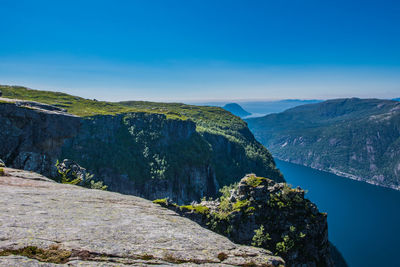 Scenic view of mountains against blue sky