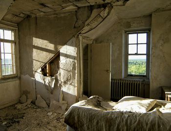 Abandoned interior with peeled wall and windows