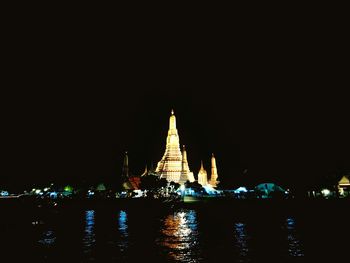 Illuminated temple against sky at night