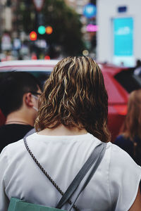 Rear view of friends standing against blurred background