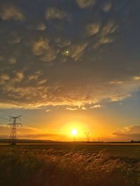 Scenic view of sunset over field