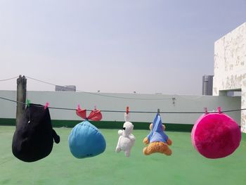 Close-up of clothes drying against clear sky