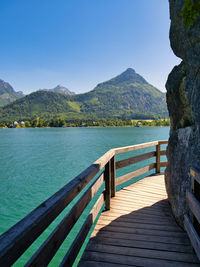 Pier over lake against blue sky