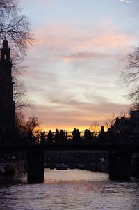 Scenic view of silhouette city against sky during sunset