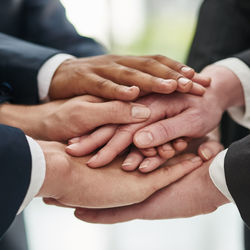 Close-up of business people stacking hands
