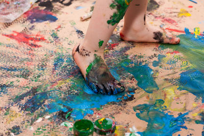 Little girl walking on fresh paint with bare foots