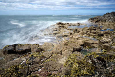 View of calm sea against cloudy sky