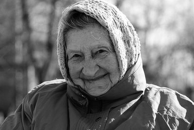 Close-up portrait of smiling senior woman in warm clothing