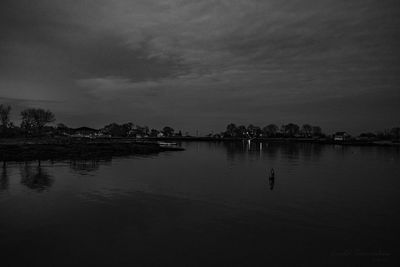 Scenic view of lake against sky at dusk