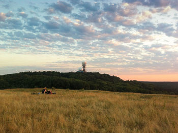Scenic view of field against sky at sunset