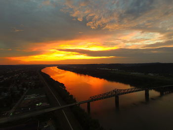 High angle view of robert c byrd bridge over ohio river against orange sky