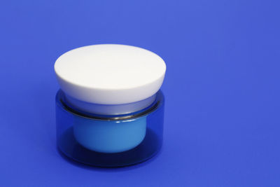 Close-up of tea cup on table against blue background