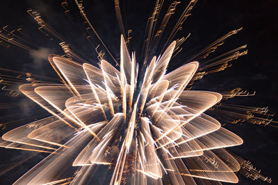 Low angle view of firework display at night