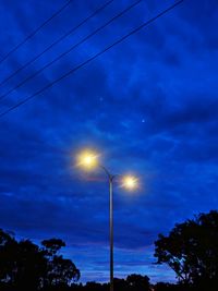 Low angle view of street light against sky at night
