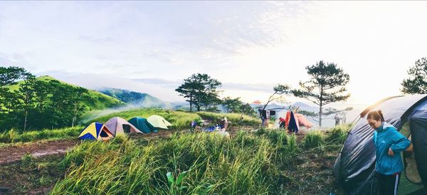 People in tent against sky