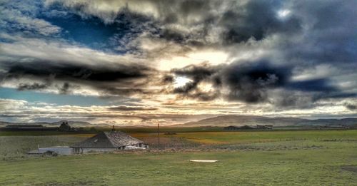 Scenic view of landscape against cloudy sky