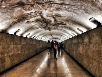 Rear view of people walking in subway