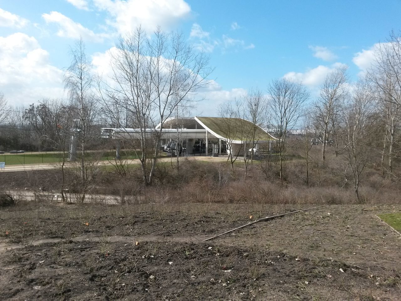 HOUSES ON FIELD AGAINST SKY