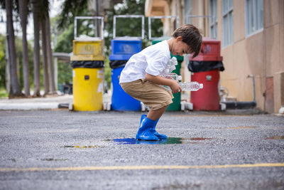 Side view of boy playing on the road