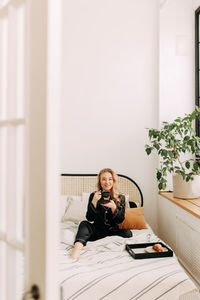 Portrait of smiling man sitting on sofa at home