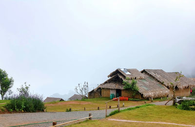 Houses on field against sky