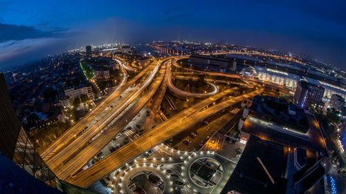 High angle view of illuminated city against sky at night