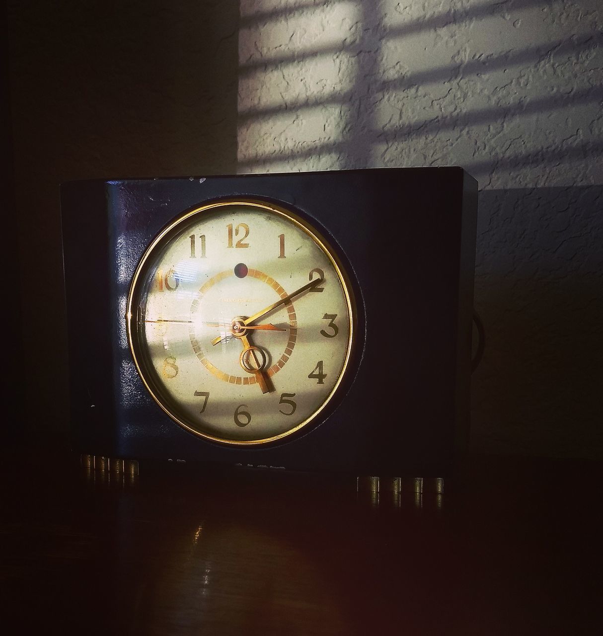 CLOSE-UP OF CLOCK ON TABLE