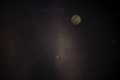 Low angle view of moon against sky at night