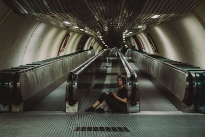 Rear view of woman in tunnel