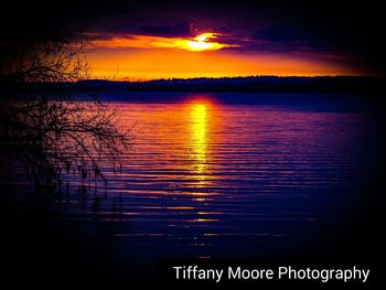 Scenic view of lake against romantic sky at sunset