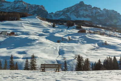 Snow covered land and mountains against sky