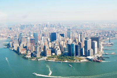 Panoramic view of sea and cityscape against sky