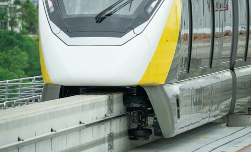 Elevated monorail train on rail. guide wheels rubber tire on concrete guideway beam with conductor