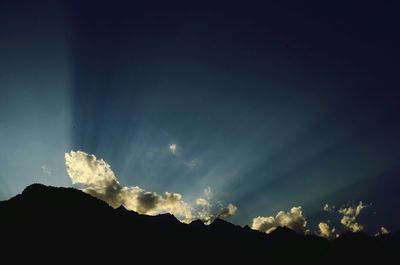 Scenic view of mountains against cloudy sky