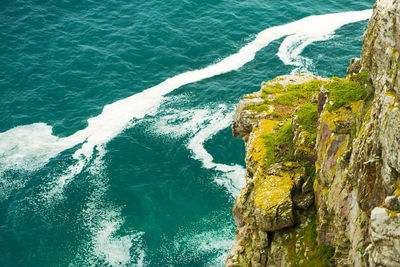 High angle view of cliff by sea