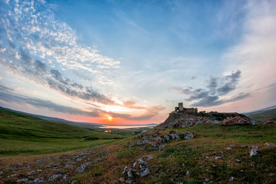 Scenic view of field against sky during sunset