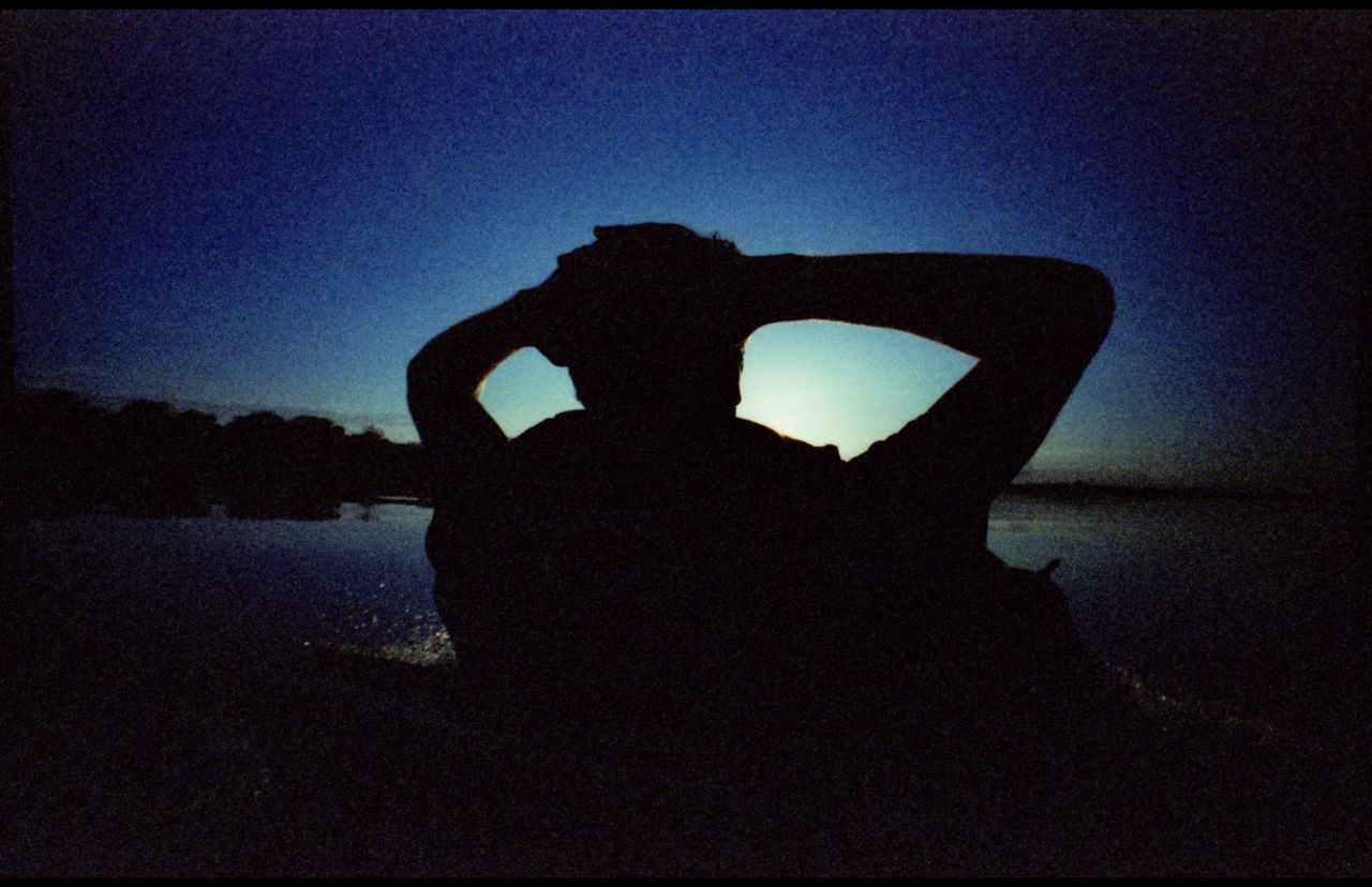 SILHOUETTE WOMAN HAND AGAINST SKY AT SUNSET