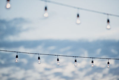 Low angle view of light bulbs hanging from ceiling