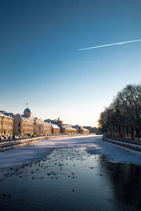 Scenic view of building against clear blue sky during winter