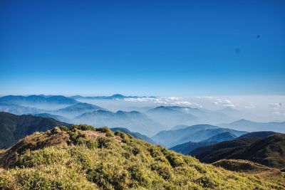 Scenic view of mountains against clear blue sky