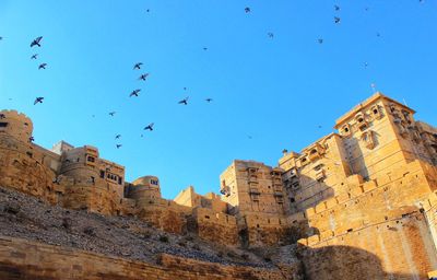 Low angle view of buildings against blue sky